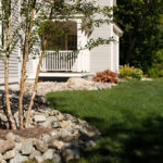 Rock-On-river-stone-vs-bark-mulch;-inserted-trees-and-low-plantings